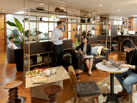 Coworking area at 17 State Street, New York, where clients interact and collaborate in a dynamic, professional environment.